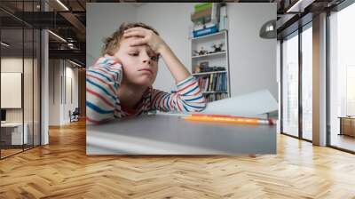 Child tired and bored of doing homework, kid stressed from learning Wall mural