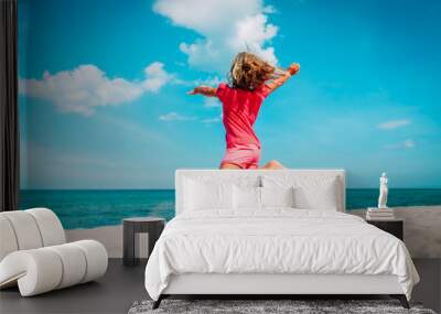 cute little girl dance play at summer beach Wall mural