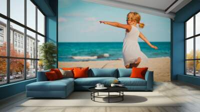 cute little girl dance play at summer beach Wall mural