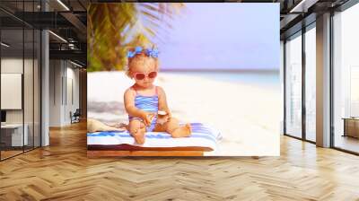 cute little girl with seashells on summer beach Wall mural