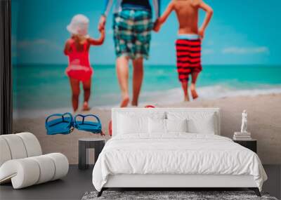 family shoes and father with kids walking at beach Wall mural