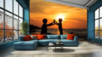 father and son playing at sunset Wall mural