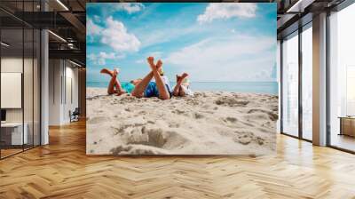 father with son and daughter relax on beach Wall mural