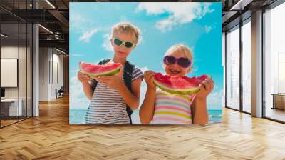 happy boy and girl eat watermelon at beach, healthy lifestyle Wall mural