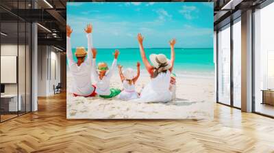 happy family with kids hands up on beach Wall mural