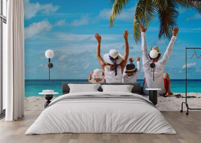 happy family with two kids hands up on the beach Wall mural