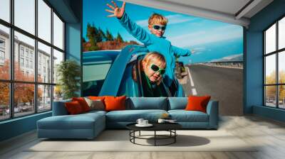 happy little boy and girl enjoy travel by car in mountains Wall mural