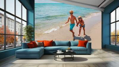 happy little girl and boy running at beach Wall mural