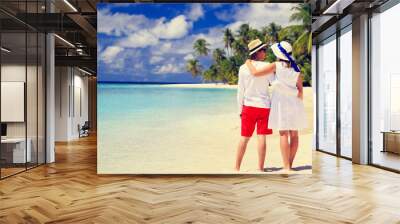 happy loving couple walking on tropical beach Wall mural