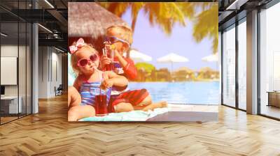 kids relax on tropical beach resort and drink juices Wall mural