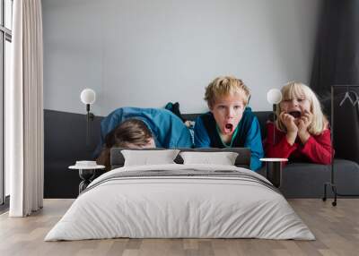 kids shout and make noise while father is stressed and tired Wall mural