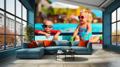 little boy and girl playing in swimming pool at beach Wall mural