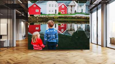 little boy and girl travel in traditional village of Norway Wall mural