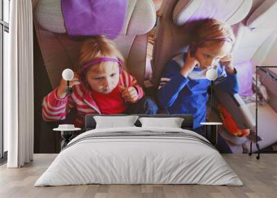 little girl and boy watch tv on flight Wall mural