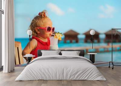 little girl drinking cocktail on tropical beach Wall mural