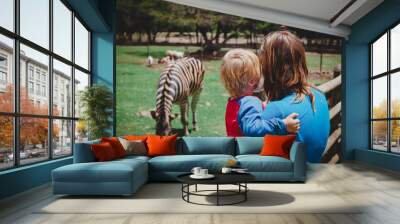 mother and little son looking at zebra Wall mural