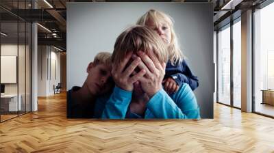 sad little boy and girl hugging father, family in sorrow Wall mural