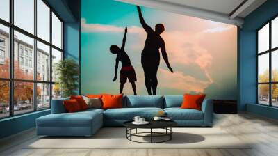 Silhouette of family play at sunset sky Wall mural