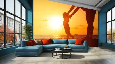 Silhouette of father and little daughter at sunset Wall mural