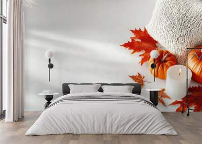   A few pumpkins sit on the table with white candles and autumn leaves around them Wall mural