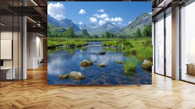  A lush green forest surrounds a river that flows towards tall, grass-covered mountains in the distance Wall mural