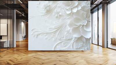   A white flower on a white background with white swirls and flowers adorning the wall is captured in this close-up Wall mural