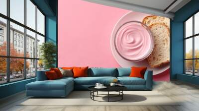   Pink surface with a white plate featuring two slices of bread and a jar of mayonnaise Wall mural