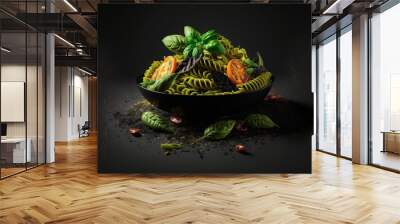 a bowl of pasta with basil and tomatoes on a black background with spices and pepper sprinkles., generative ai Wall mural