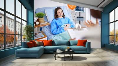 Healthcare, woman and patient with recovery, smile and consultation with good news, help and treatment. Female person, doctor and lady in a hospital bed, healing and diagnosis with procedure success Wall mural