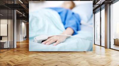 Person, hand or sleeping in hospital bed for medical treatment, surgery and icu operation in clinic. Tired, blur or sick patient lying or resting in emergency room for healthcare or wellness recovery Wall mural