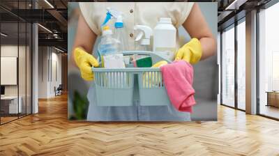 Woman, hands and detergent basket for cleaning, housekeeping or disinfection of dirt at home. Closeup of female cleaner holding container of chemical bottles, products or liquid tools of maid service Wall mural