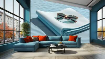 pair of sunglasses on a blue blanket on a beach. generative ai.vacation and relaxation concept Wall mural