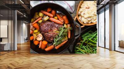 Pot roast in a cast iron dutch oven, green beans and mushed potato. Wall mural