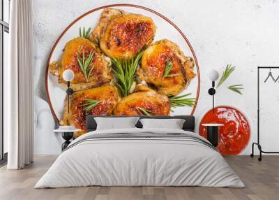 Baked chicken thighs with herbs on white plate. Wall mural