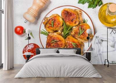 Baked chicken thighs with herbs on white plate. Wall mural