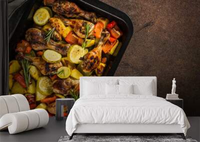 Baked chicken with vegetables preparing in the oven at baking sheet. Top view. Wall mural