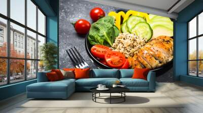 Buddha bowl quinoa salad with chicken and vegetables on black. Wall mural