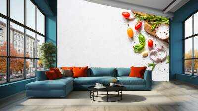 Food cooking background on white kitchen table. Fresh vegetables, herbs and spices with wooden cutting board. Top view with copy space. Wall mural