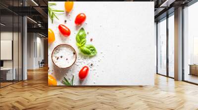 Food cooking background on white stone table. Fresh vegetables, herbs and spices. Ingredients for cooking with space for text. Wall mural