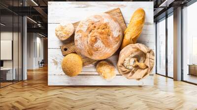 Fresh bread and buns at white table Wall mural