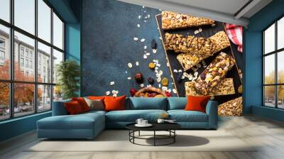 granola bar with nuts, fruit and berries on black. Wall mural