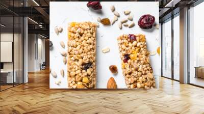 Granola bar with nuts, fruit and berries on white. Wall mural