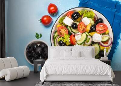 Greek salad on blue table. Wall mural