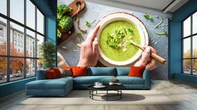 Green soup. Broccoli cream soup with cream and parmesan. Healthy vegan dish. Top view at white table. Wall mural