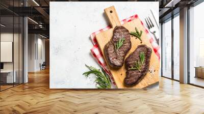 Grilled beef steak on wooden cutting board. Wall mural