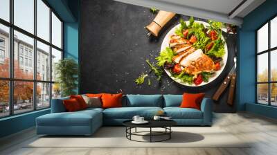 Grilled chicken with fresh salad at black. Wall mural