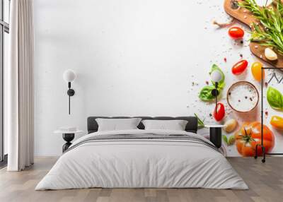 Ingredients for cooking on white stone table. Vegetables, herbs and spices with wooden cutting board. Top view with space for text. Wall mural