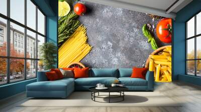 Italian food background. Pasta, herbs, vegetables on black top v Wall mural