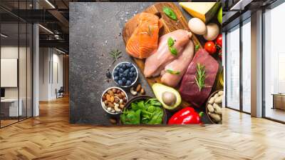 Ketogenic low carbs diet on dark stone table. Wall mural