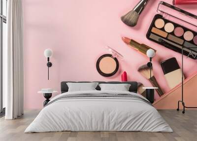 Make up products at pink background with cosmetic bag. Eye shadow, lipstick, powder, brushes and more for professional make up. Flat lay image. Wall mural